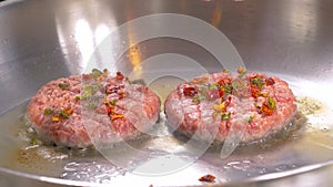 Grilled hamburger cutlets or burger patties on frying pan, closeup