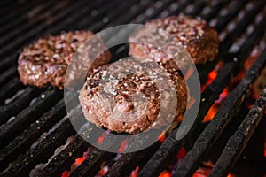 Grilled hamburgers on charcoal coals