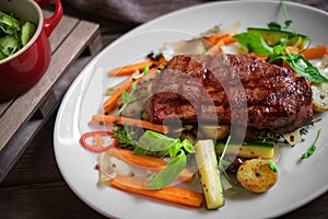 Grilled Juicy Striploin beef steak with vegetables on plate