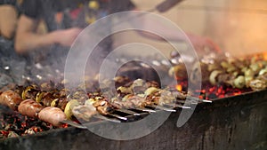 Grilled kebab cooking on metal skewer closeup. Roasted meat cooked at barbecue. BBQ fresh beef meat chop slices
