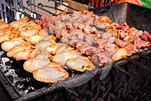 Grilled kebab cooking on metal skewer. Roasted meat cooked at barbecue. BBQ fresh beef chicken and pork meat chop slices. Traditio