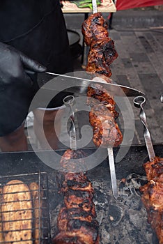 Grilled kebab cooking on metal skewer. Roasted meat cooked at barbecue. BBQ fresh beef meat chop slices