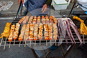 Grilled kebab cooking on metal skewer. Roasted meat cooked at barbecue. BBQ fresh beef meat chop slices