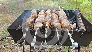 Grilled kebab cooking on metal skewer. Roasted meat cooked at barbecue. Traditional eastern dish, shish kebab. Grill on