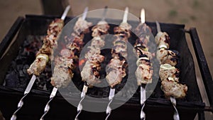 Grilled kebab cooking on metal skewer. Roasted meat cooked at barbecue. Traditional eastern dish, shish kebab. Grill on