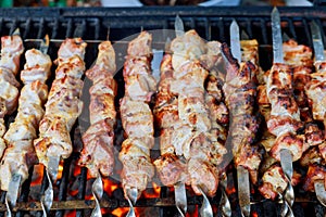 Grilled kebab cooking on skewers. Grill with charcoal and flame