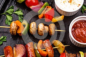 Grilled kebabs with meat, mushrooms and vegetables