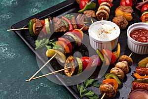 Grilled kebabs with meat, mushrooms and vegetables