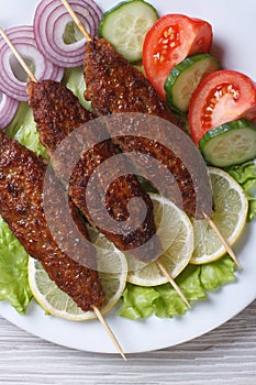 Grilled kebabs with vegetables close-up. top view vertical