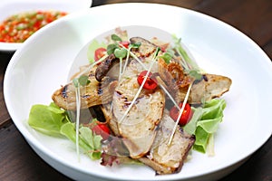 Grilled King Oyster Mushroom , Eryngii slices with sunflower sprout and green oak lettuce on white plate