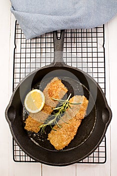 Grilled kipper with oat bran in a cast iron pan