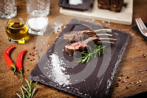 Grilled lamb chops served with a branch of rosemary