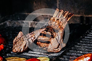 Grilled lamb ribs on grill. Hot rack of lamb with grilled vegetables, Culinary, cooking, bakery concept