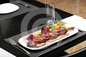 Grilled lamb ribs in a white plate