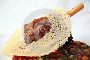 Grilled lamb shank food decorated with fancy cracker on top of it