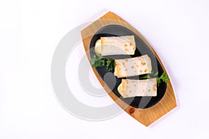 Grilled lavash rolls with suluguni cheese, picnic lunch, appetizer, delicious dish in a frying pan on a white isolated