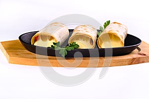 Grilled lavash rolls with suluguni cheese, picnic lunch, appetizer, delicious dish in a frying pan on a white isolated