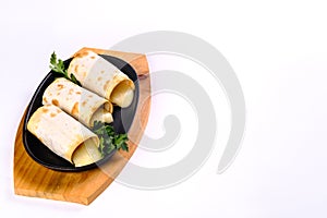 Grilled lavash rolls with suluguni cheese, picnic lunch, appetizer, delicious dish in a frying pan on a white isolated