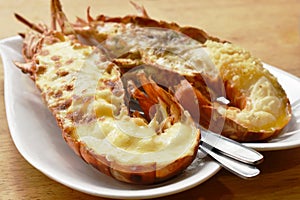 Grilled lobster shrimp with cheese and butter garlic on plate