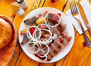 Grilled lula kebab - meat dish, with vegetable and onion. Popular oriental dish closeup