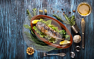 Grilled mackerel fillets with lemon on rustic background