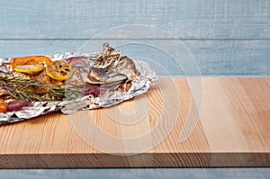 Grilled mackerel fish on a kitchen wooden table