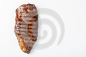 Grilled marbled beef steak striploin isolated on white background, top view with copy space