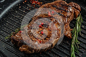 grilled marbled beef steak striploin with spices in a grill pan. place for text, top view