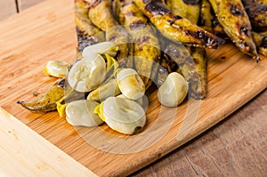 Grilled marinated fava beans on board