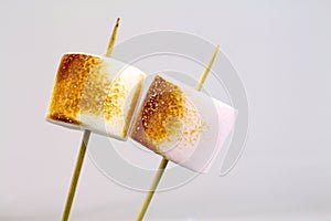 Grilled marshmallows on sticks