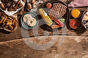 Grilled Meal Spread Out on Rustic Wooden Table