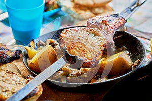 Grilled meat and baked potatoes