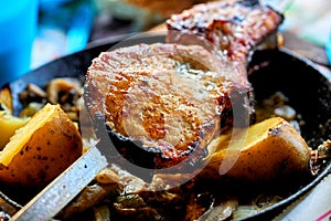 Grilled meat and baked potatoes