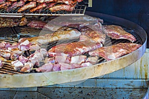 Grilled meat. Close-up cooking of large juicy pieces of raw, fat, natural, marinated pork meat, beef calves, rams on a griddle