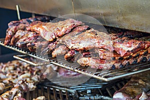 Grilled meat. Close-up cooking of large juicy pieces of raw, fat, natural, marinated pork meat, beef calves, rams on a griddle