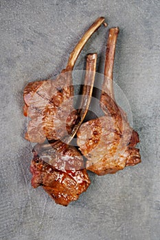 Grilled meat on grey concrete background