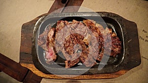 Grilled meat. Grilled beef steak medium rare on wooden cutting board. Top view