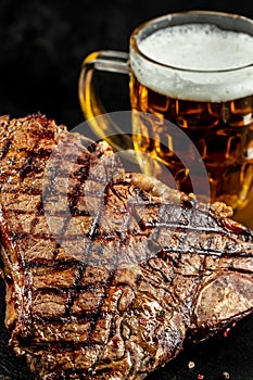 grilled meat and mug of beer. T-bone or porterhouse beef meat Steak. Restaurant menu, cookbook recipe top view
