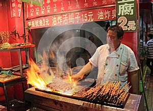 Grilled meat at night food market in Beijing