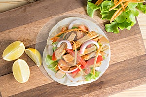 Grilled meat with onion and bell peppers, tomato,lettuce and serve with flour.