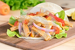 Grilled meat with onion and bell peppers, tomato,lettuce.