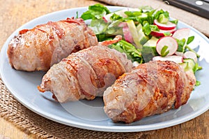 Grilled meat rolls wrapped in strips of bacon
