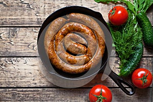 Grilled meat sausage in cast iron pan homemade traditional food