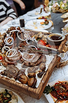 grilled meat set on a wooden board on the table