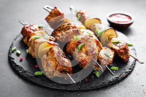 Grilled meat skewers, shish kebab on black background photo