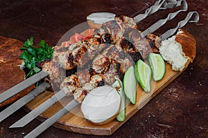 Grilled meat skewers, shish kebab, healthy vegetable fresh tomato, cucumber, onion and bread