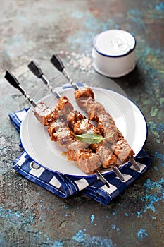 Grilled meat skewers, shish kebab on a plate