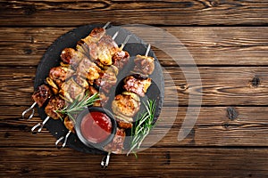 Grilled meat skewers, shish kebab on wooden background