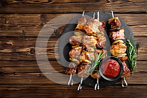 Grilled meat skewers, shish kebab on wooden background