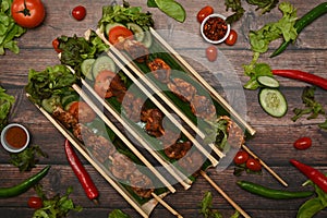 Grilled meat skewers, Sichuan pepper, Chinese spices and vegetable on wooden table